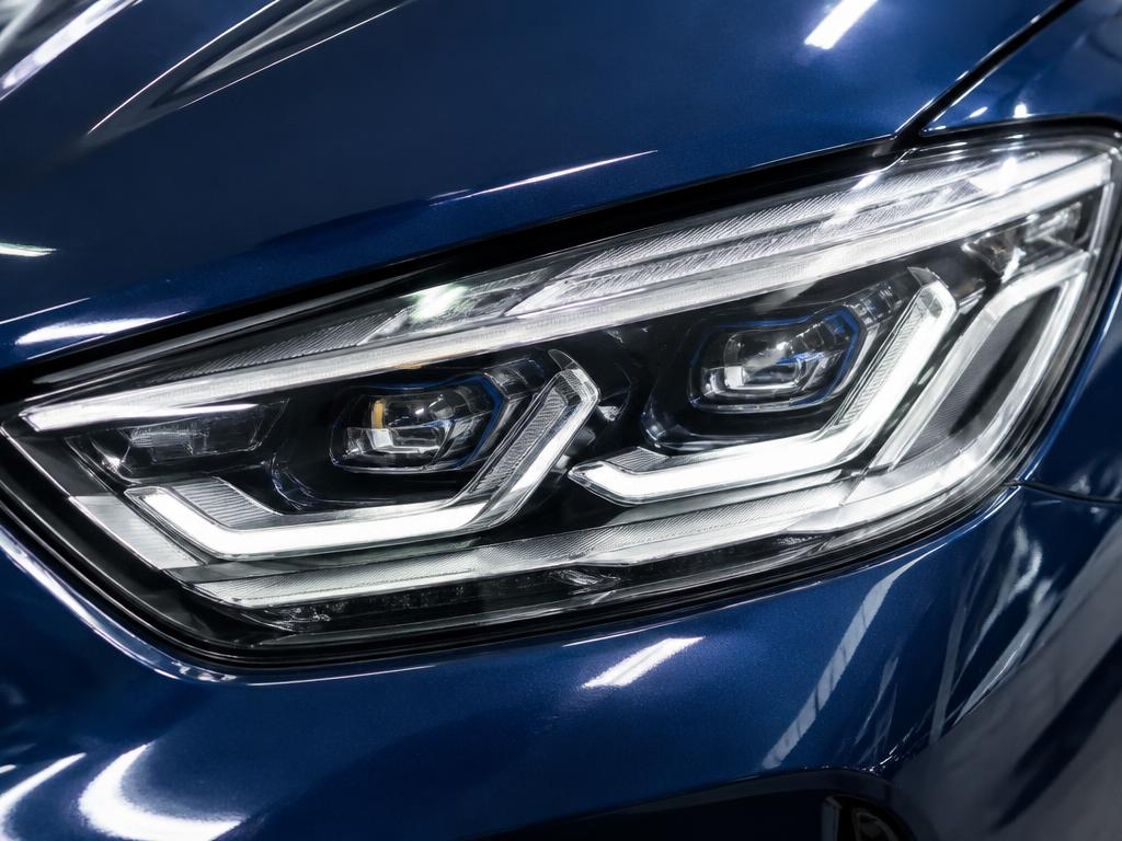 Clear modern LED headlight on a dark blue car